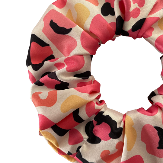 Leopard print pattern scrunchie on a white background.