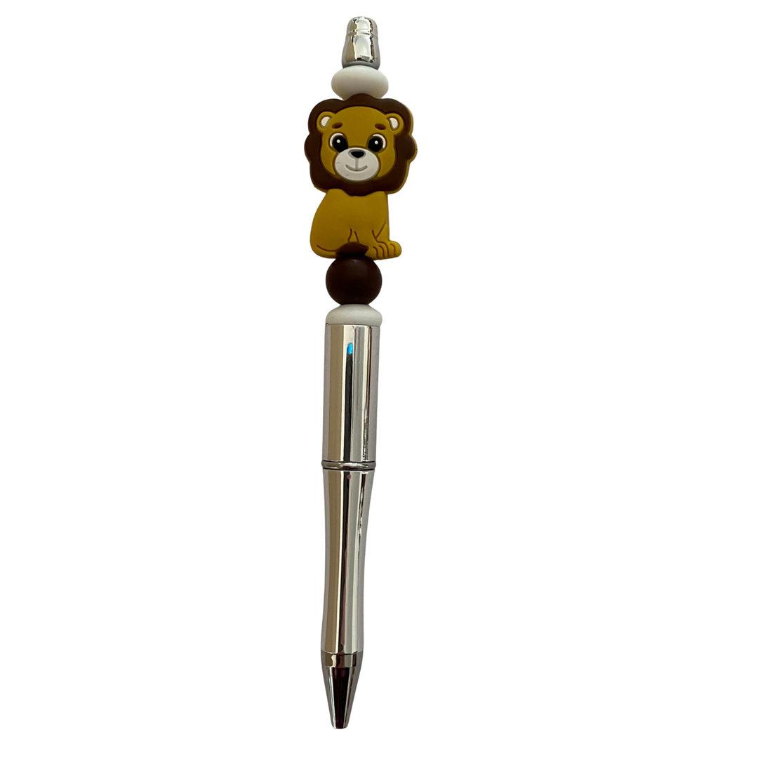 Pen with a lion silicone bead on top on a white background.