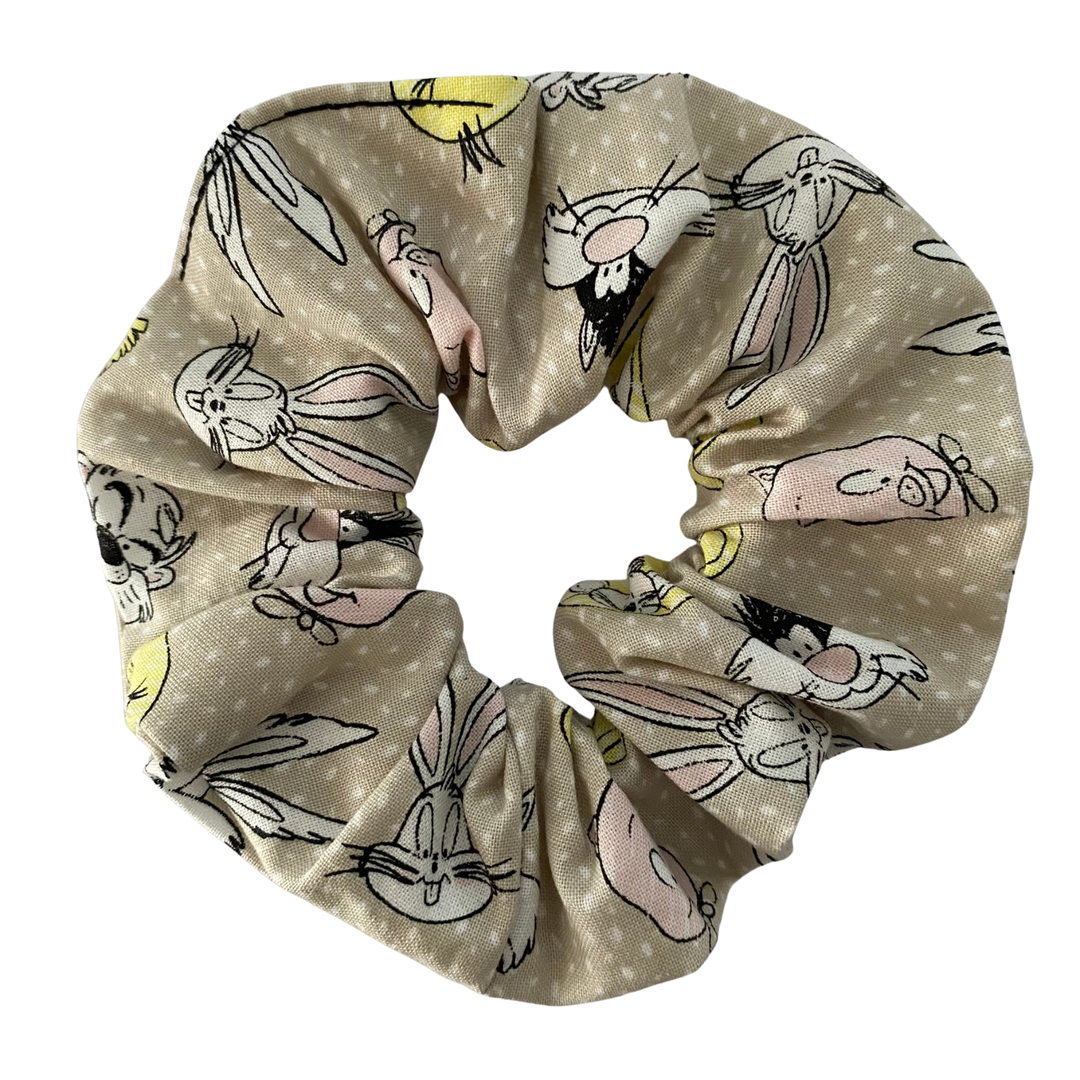 Light grey cotton scrunchie featuring a whimsical pattern of Bugs Bunny, Tweety Bird and Daffy Duck.