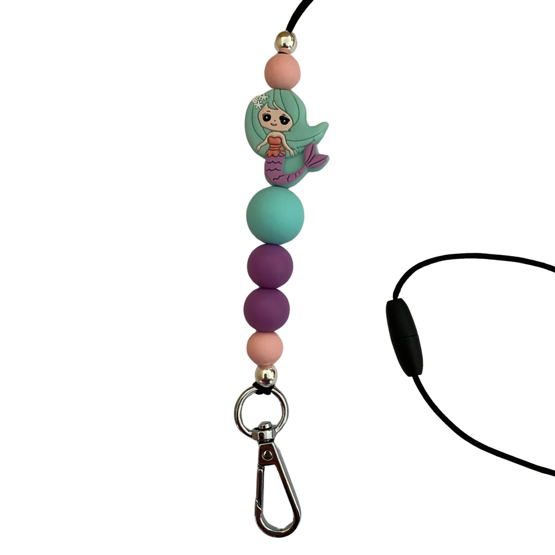 A 60cm lanyard fitted with a safety break away clasp featuring a mermaid in mint green colour bead and other coloured round silicone beads.