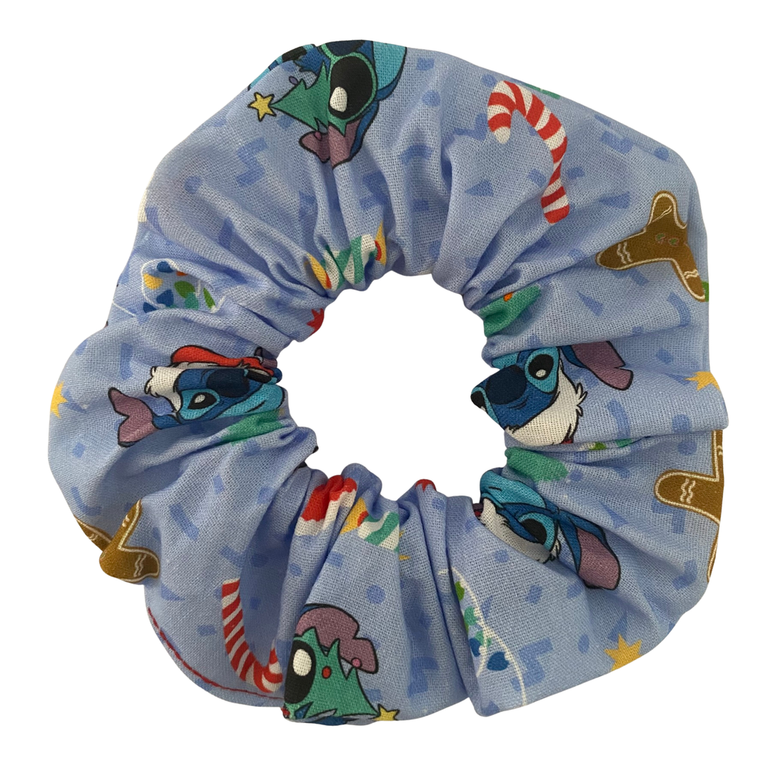 A light blue scrunchie with images of Stitch and other festive images.