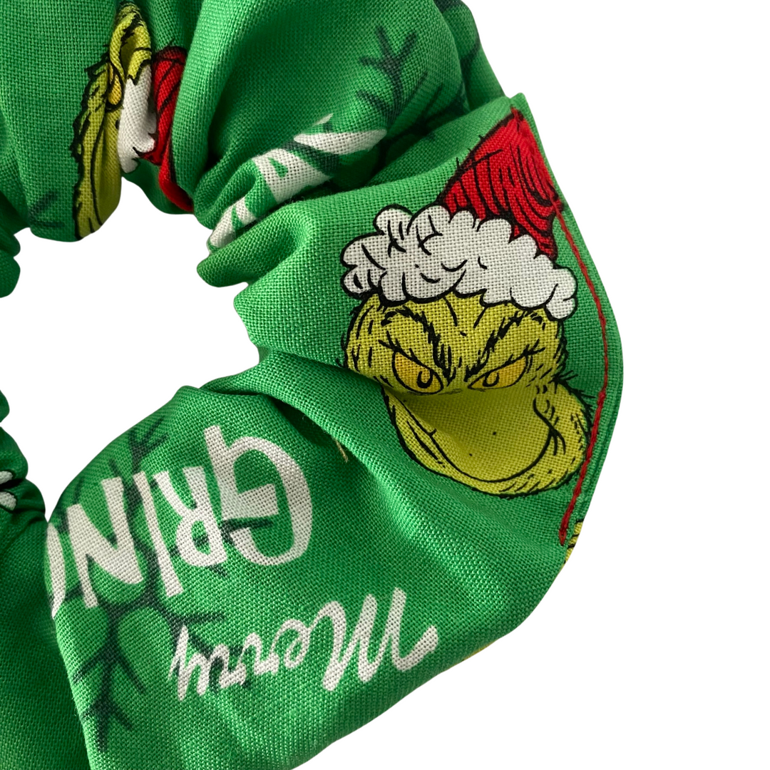 Images of the Grinch and the words Merry Grinchmas on a green fabric.
