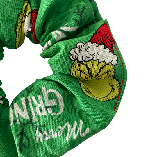 Images of the Grinch and the words Merry Grinchmas on a green fabric.