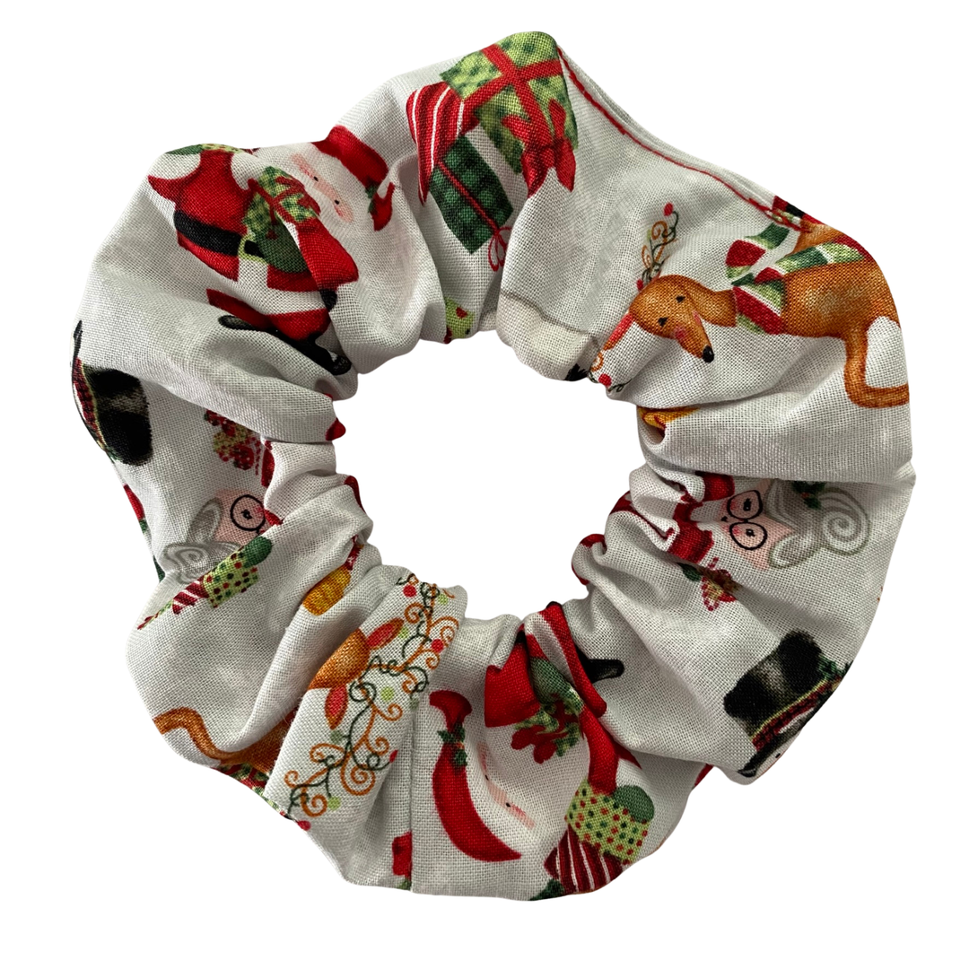 Christmas-themed scrunchie with festive patterns on a white background.