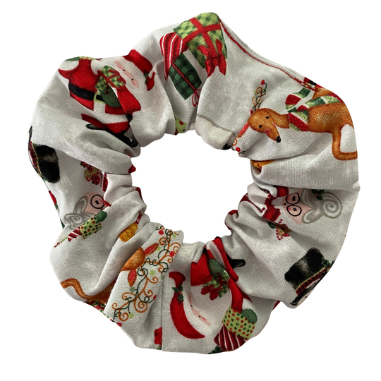 Christmas-themed scrunchie with festive patterns on a white background.
