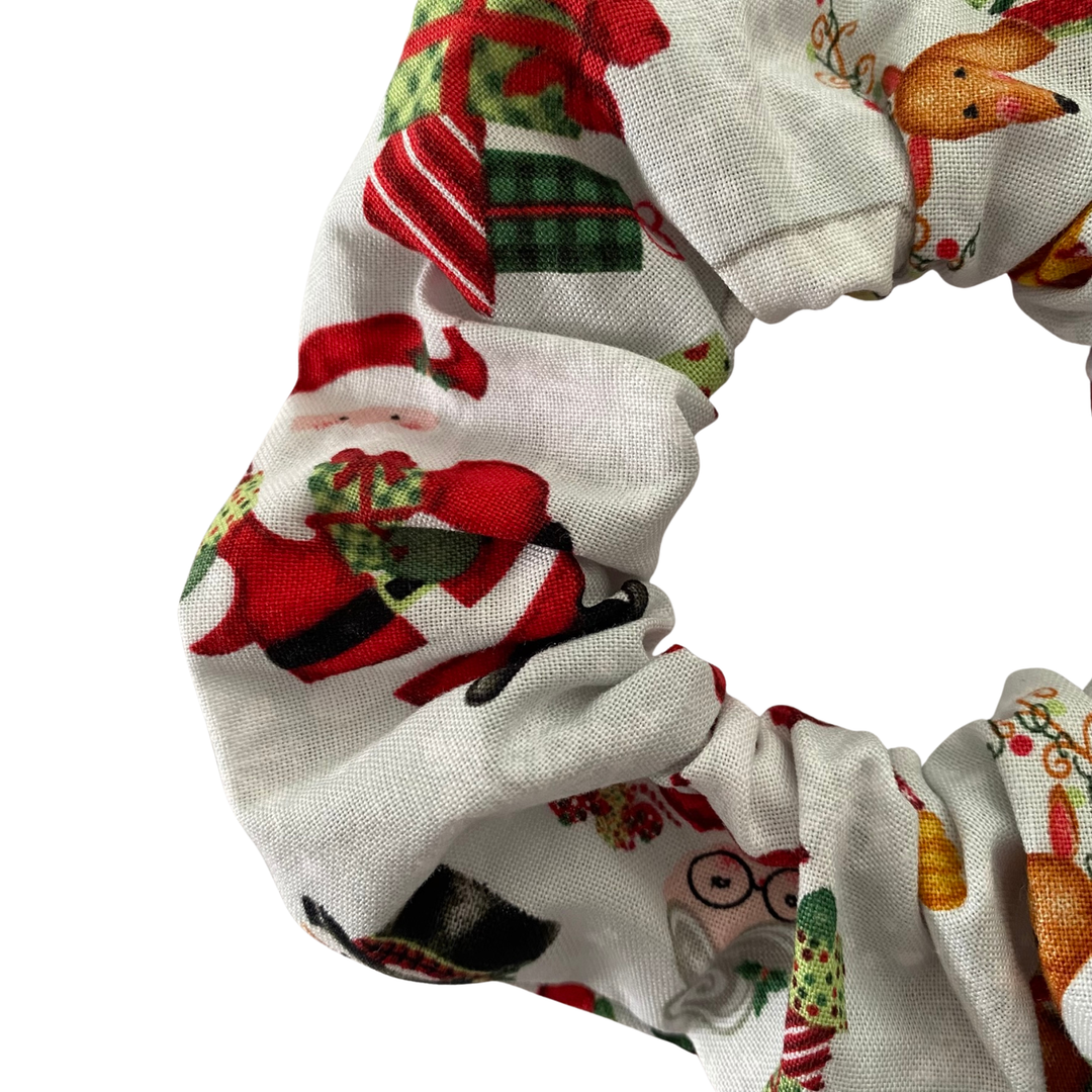 Scrunchie with Christmas-themed fabric pattern on a white background.