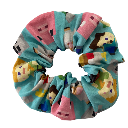 Colourful scrunchie with pixelated character pattern on a white background.