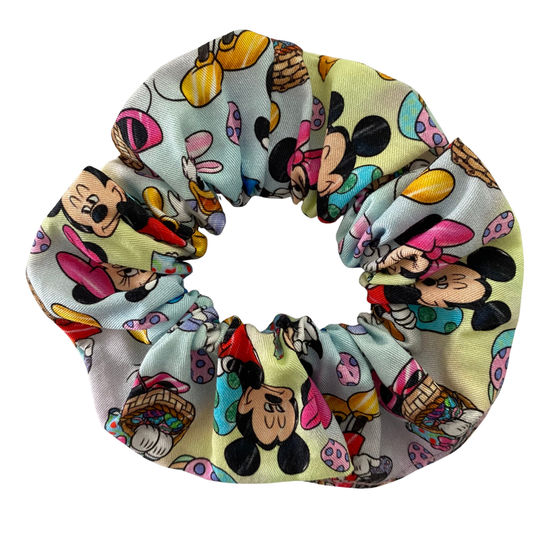 Scrunchie with illustrations of Mickey, Minnie, Donald, Daisy and Pluto surrounded by pastel-toned Easter eggs.