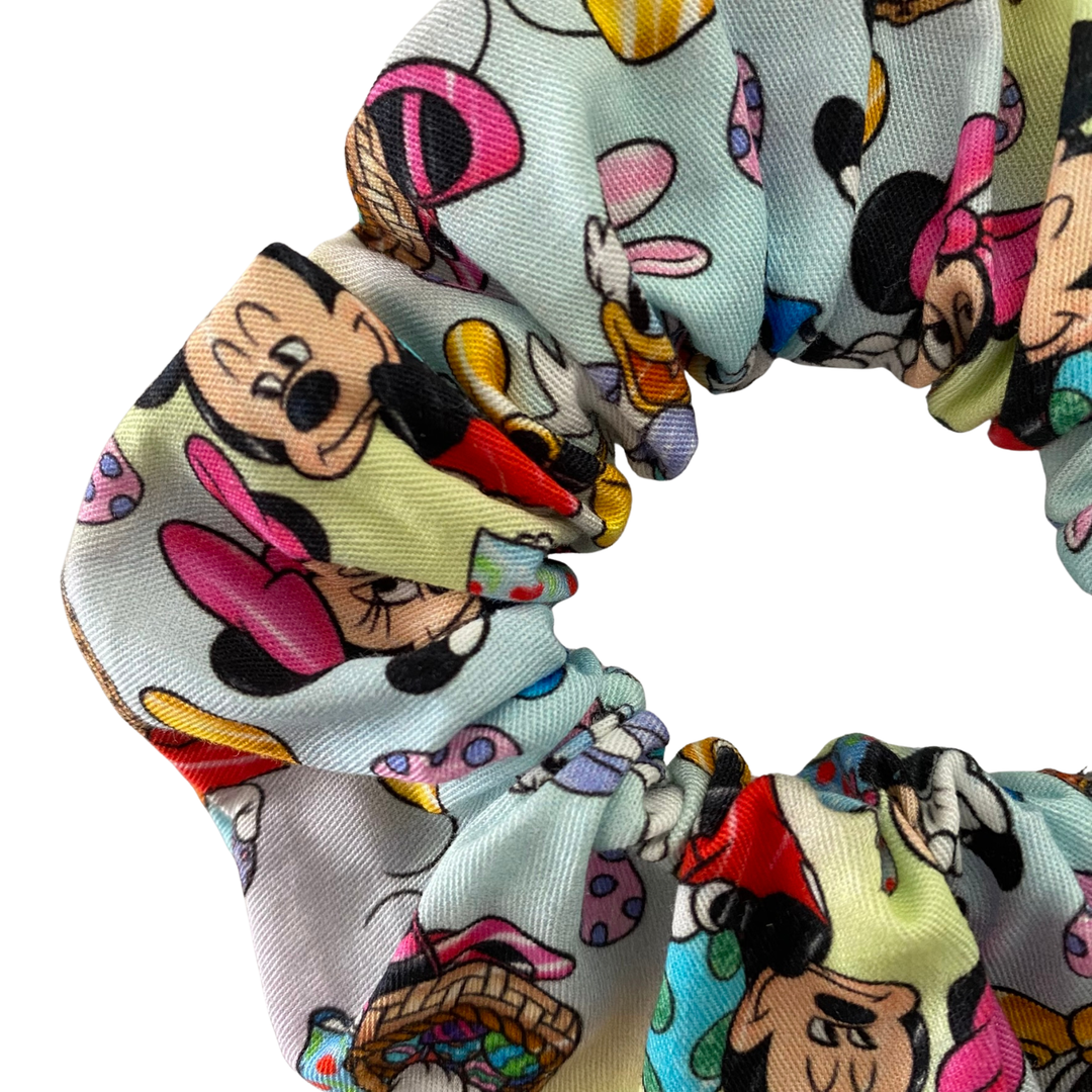 Colourful scrunchie with cartoon character design on a white background.