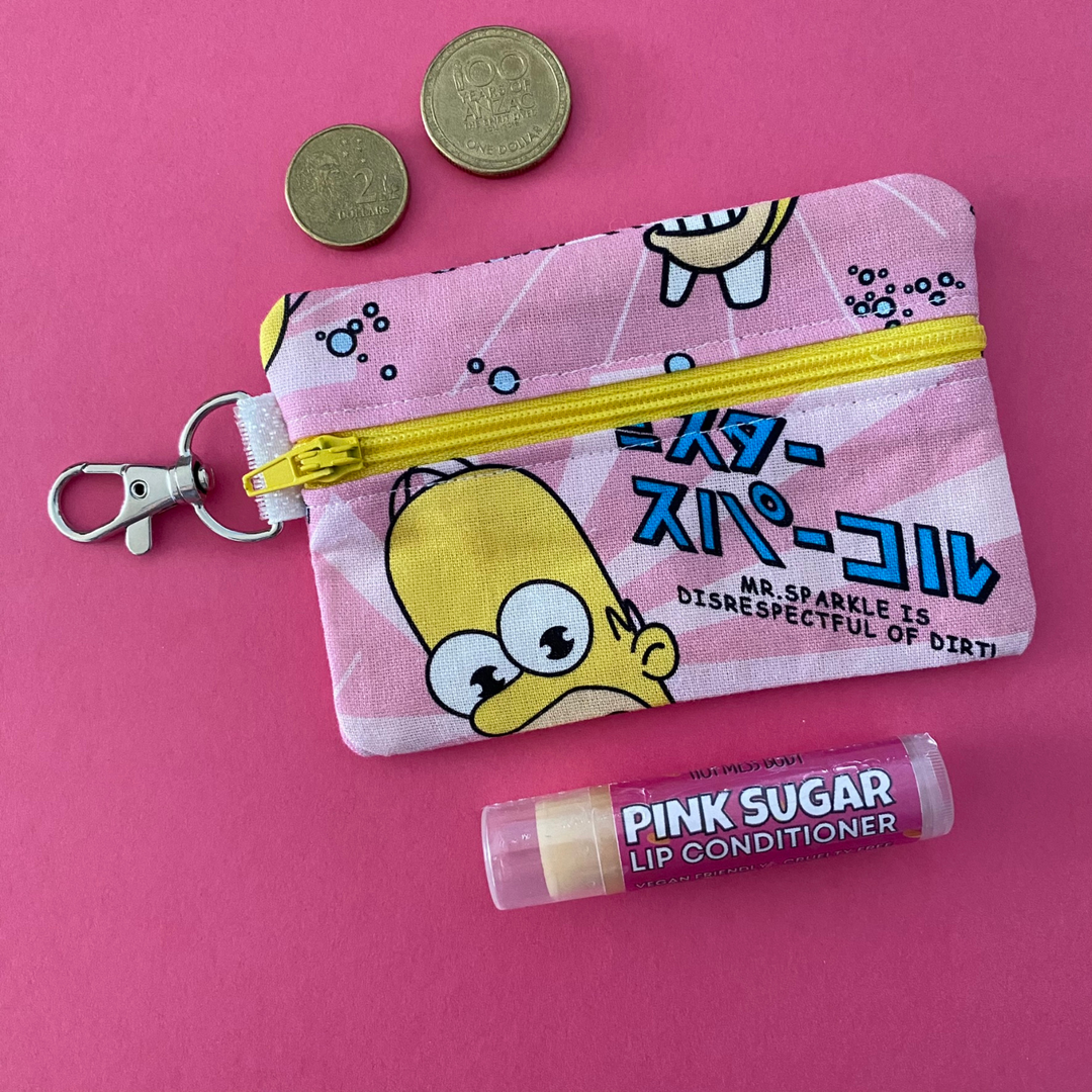 A small clip coin purse perfect for coins and small essentials featuring Mr Sparkle Homer character fabric.