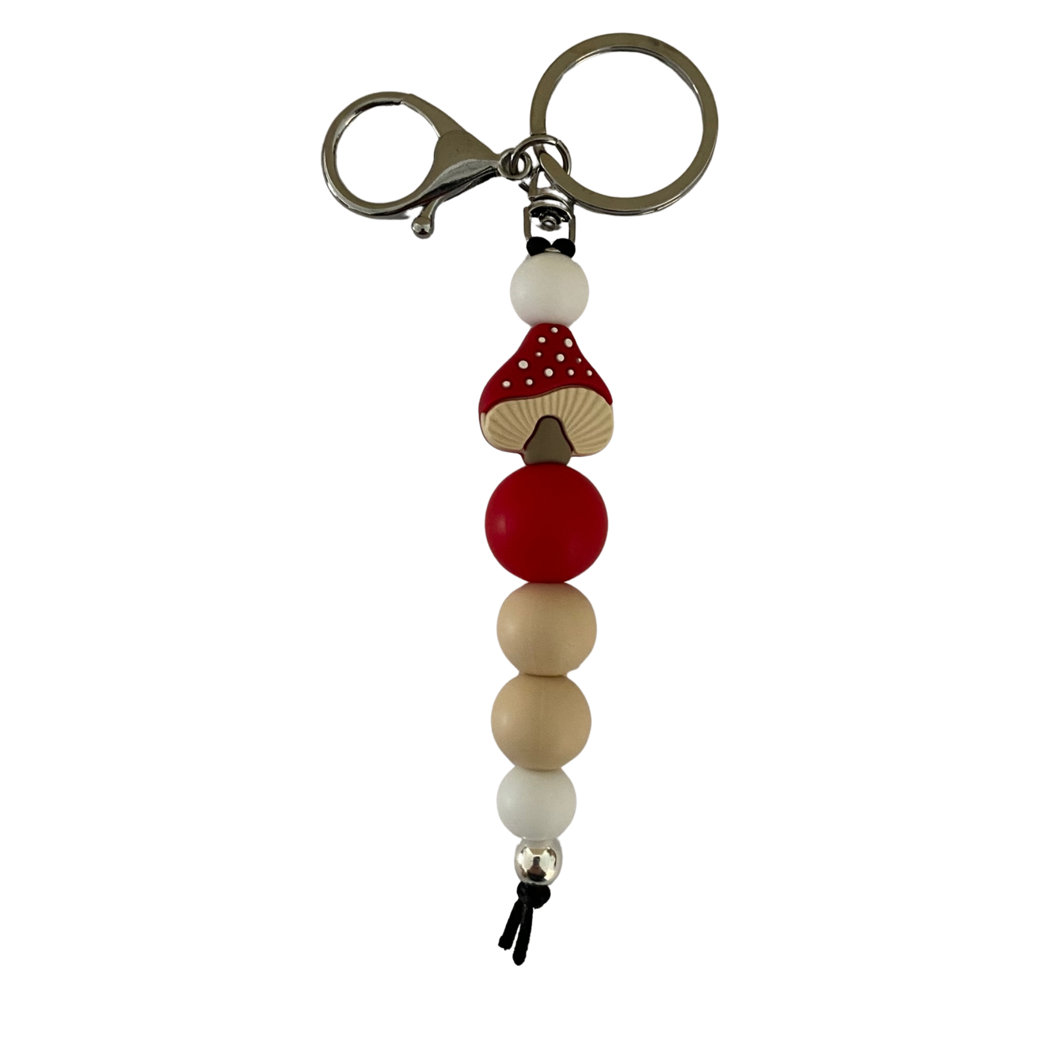 Mushroom Silicone Keyring featuring a charming red-capped mushroom bead with classic white polka dots. Durable nylon cord. Perfect for keys or bags.