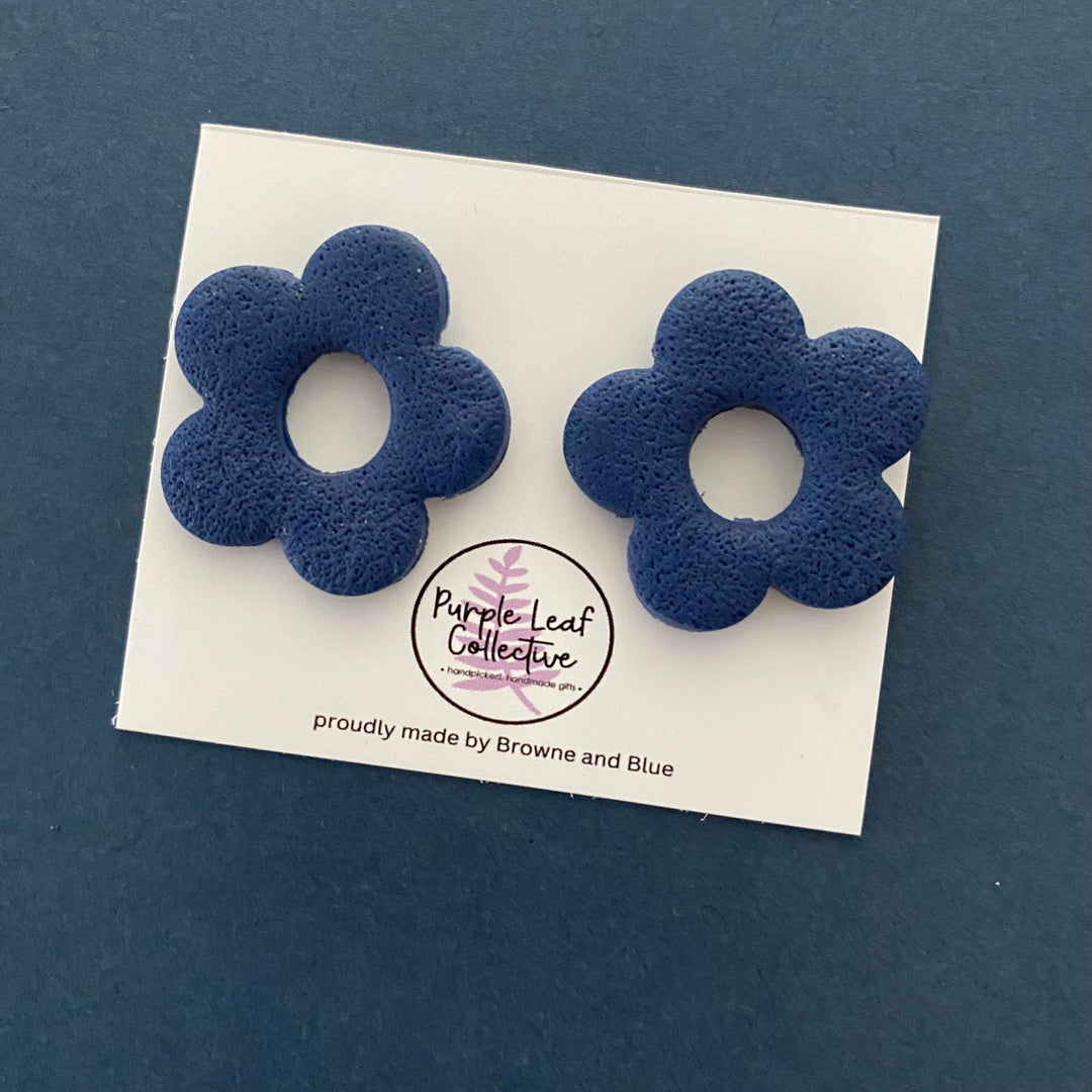 Drop stud earrings with five navy blue polymer clay flower petals, set on surgical steel posts for comfort and durability.