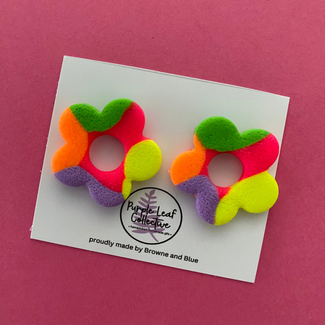 Drop stud earrings with five neon polymer clay flower petals, set on surgical steel posts for comfort and durability.