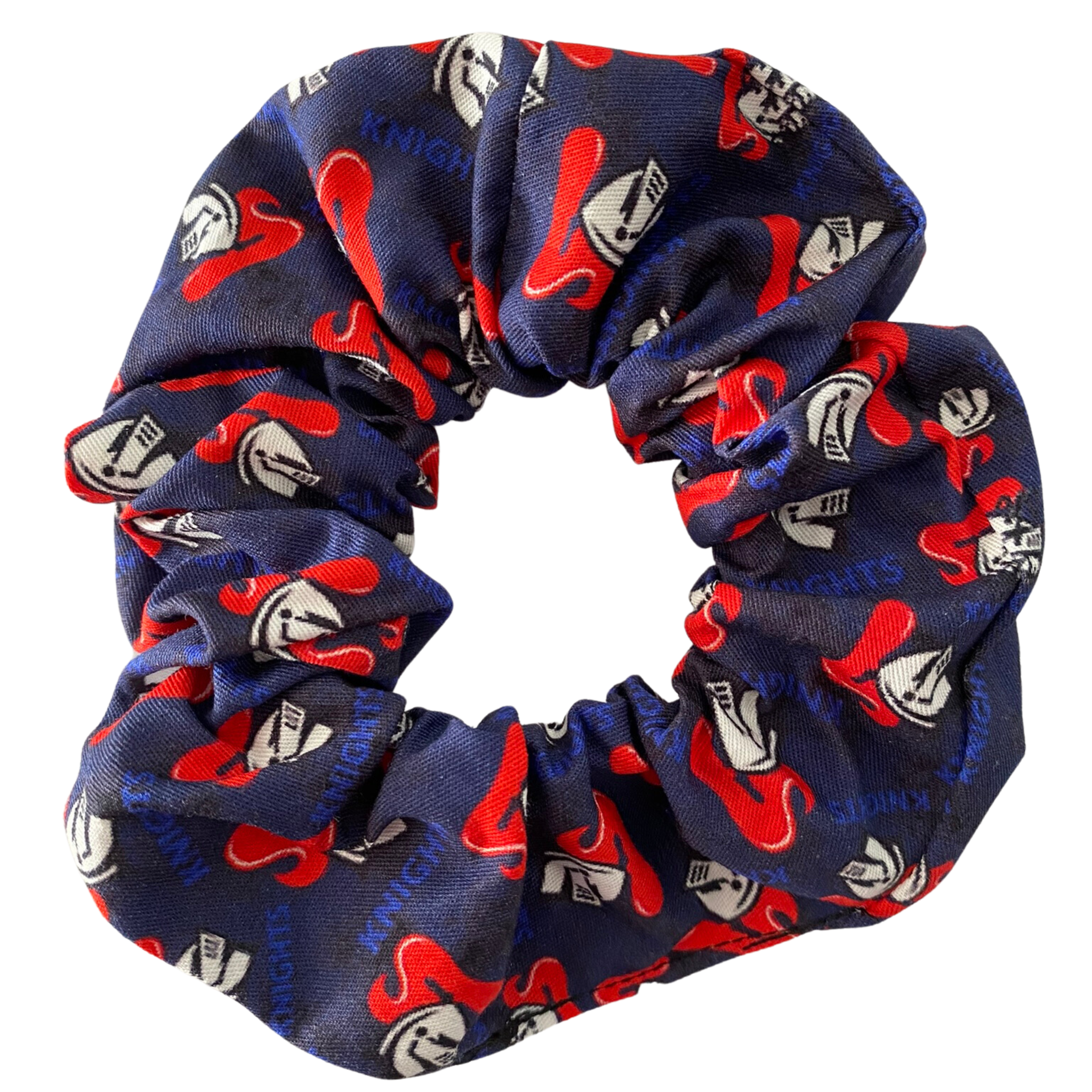 A scrunchie hair tie handmade with cotton woven fabric with images of the Newcastle Knights rugby league team.