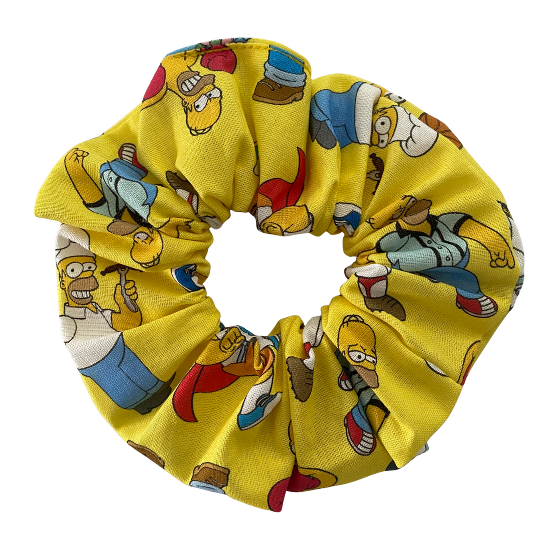 Yellow scrunchie with Homer Simpson character pattern on a white background.
