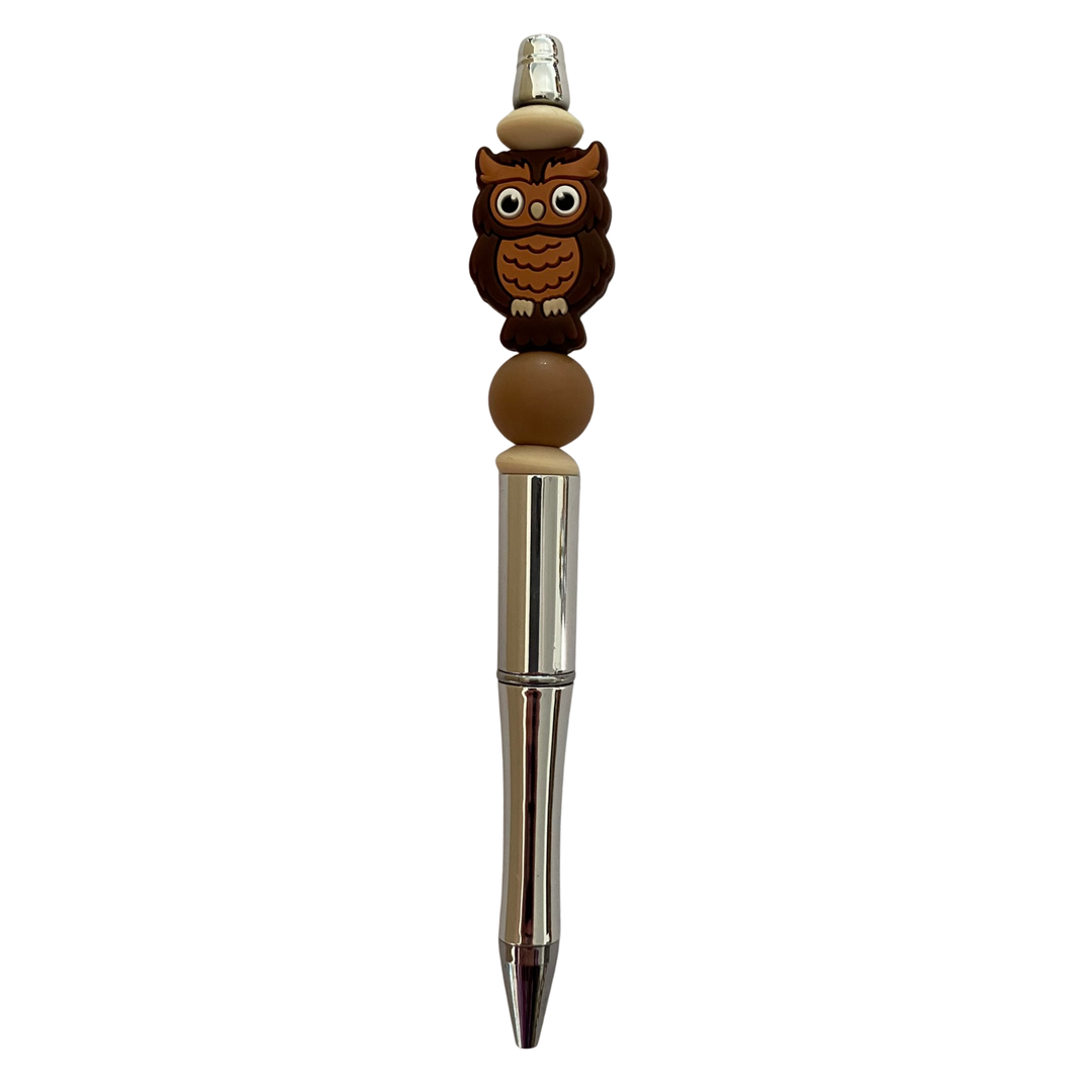 Pen with owl-shaped top on a white background.