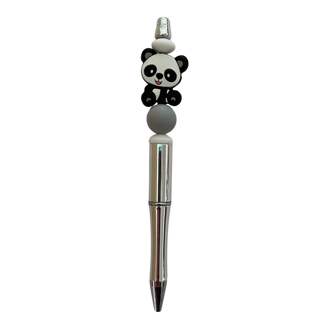 Pen with a panda silicone bead on top on a white background.