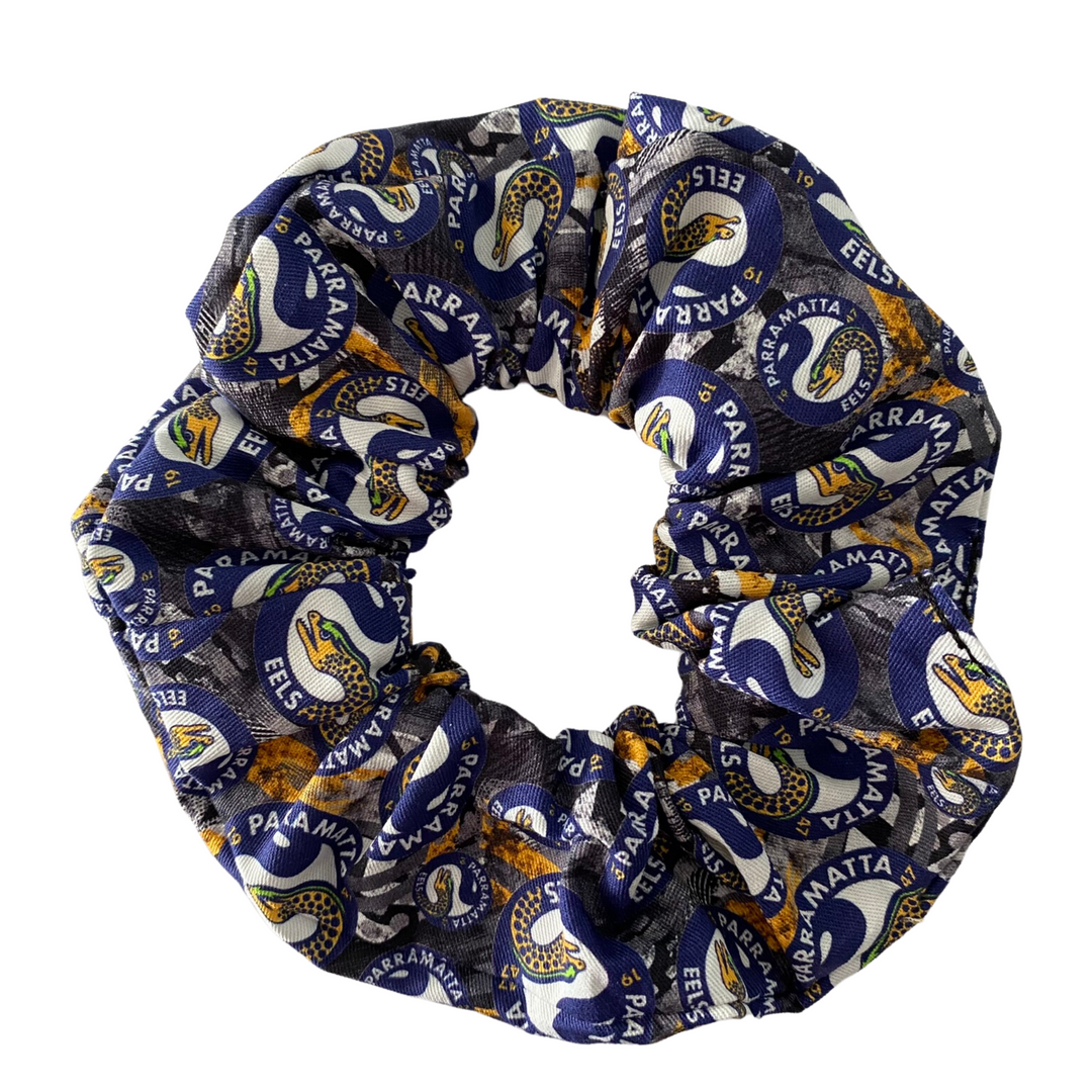 A scrunchie hair tie handmade with cotton woven fabric with images of the Parramatta Eels rugby league team.