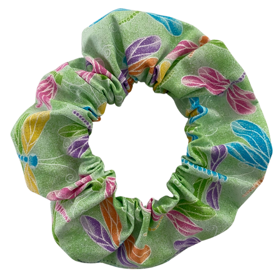 A lime green scrunchie with images of pink, purple, blue, orange and yellow dragonflies with added glitter.