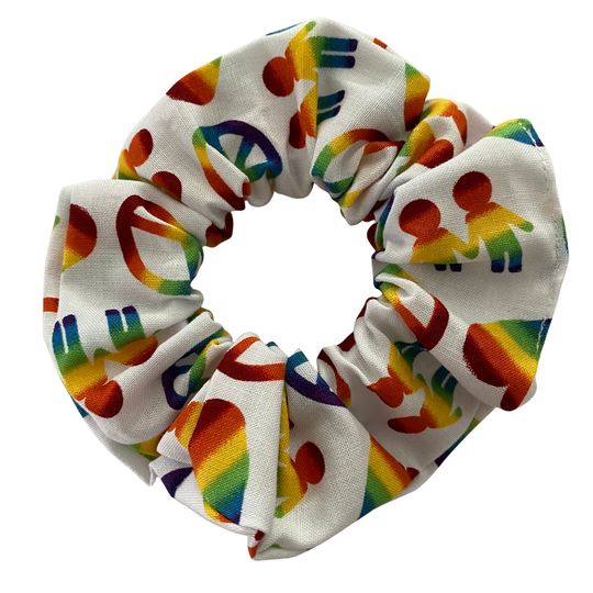 A scrunchie featuring vibrant rainbow hearts, peace signs and hand-holding figures on a white background.