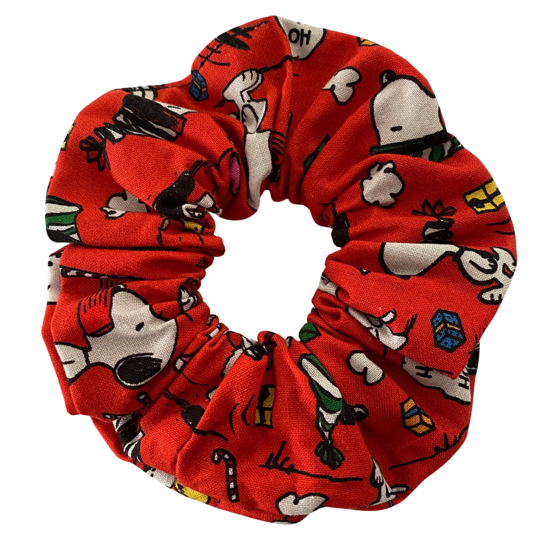 Images of Snoopy and other festive designs on a red fabric.