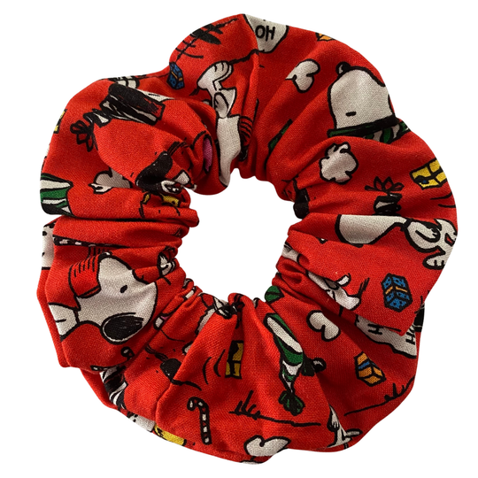 Images of Snoopy and other festive designs on a red fabric.