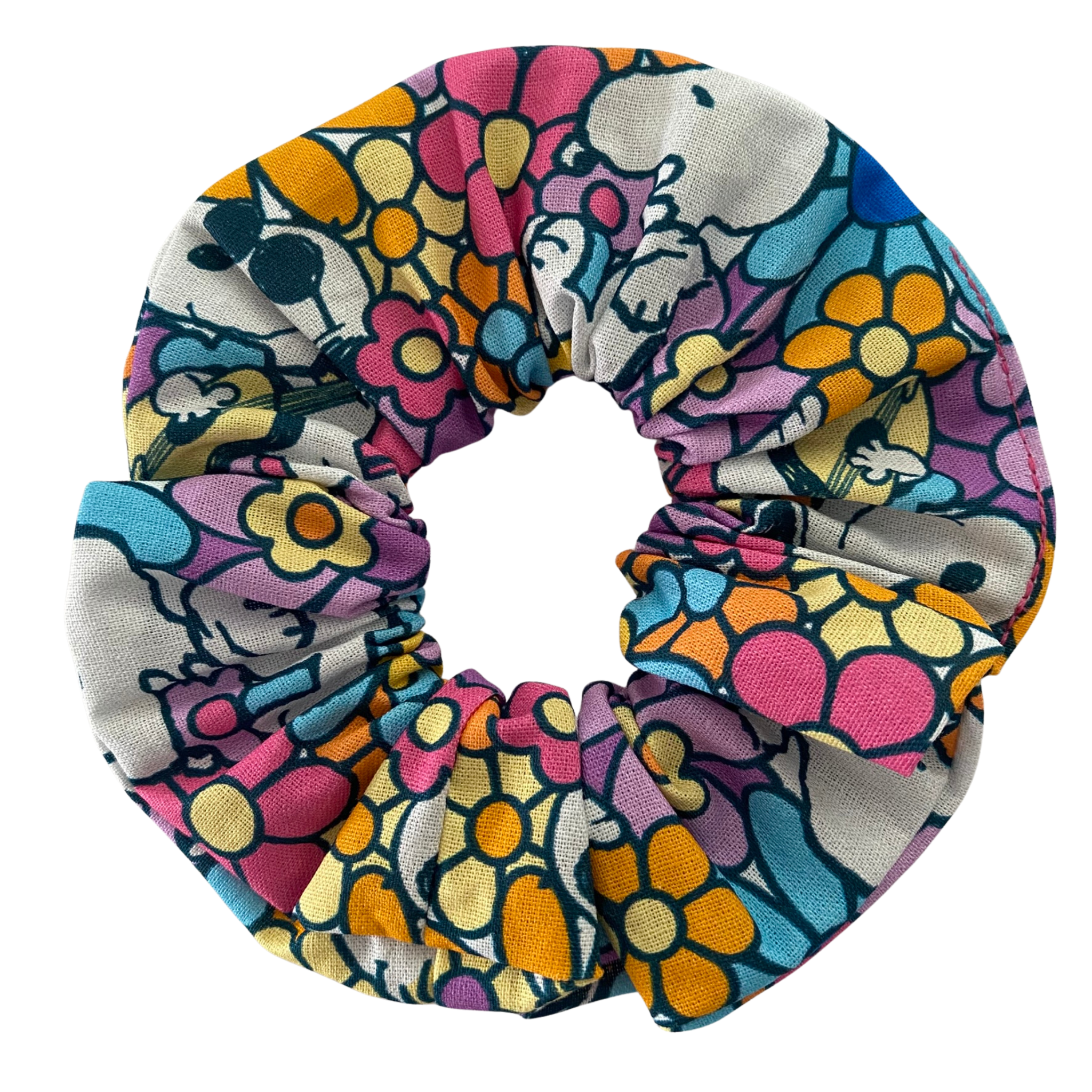 A scrunchie with playful images of Snoopy and Woodstock on a vibrant, retro-inspired floral print.
