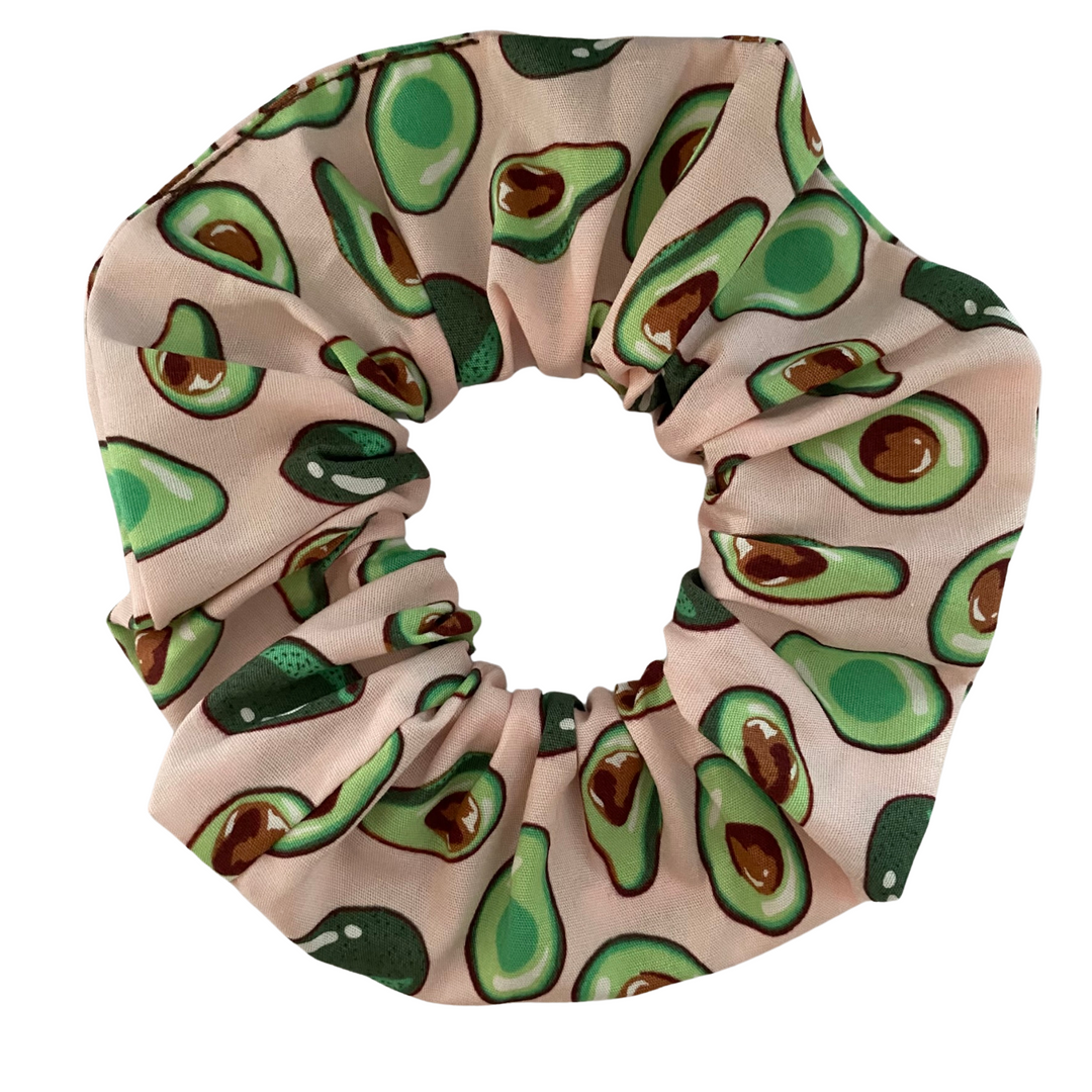 Pink Avocado Scrunchie with adorable avocado illustrations on a vibrant pink cotton poplin fabric; handmade and ideal for avocado lovers.