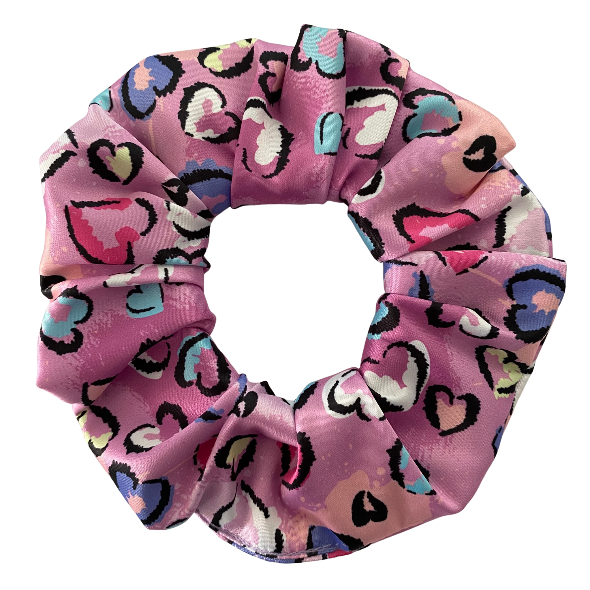 Pink scrunchie with heart pattern on a white background.