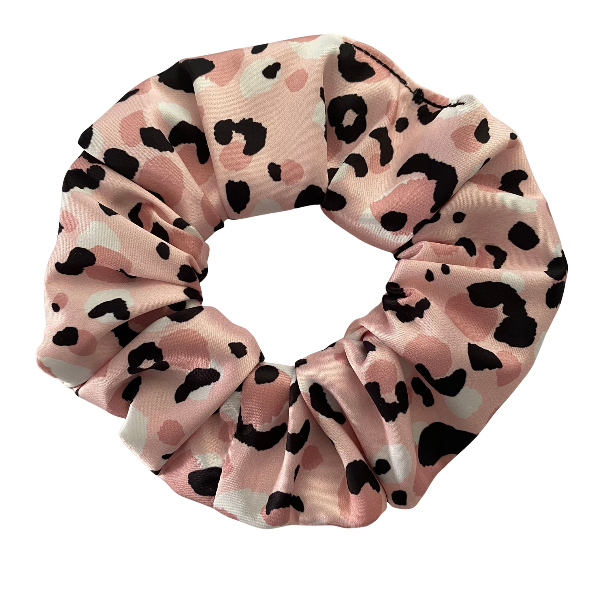 Pink scrunchie with black and white heart pattern on a white background.