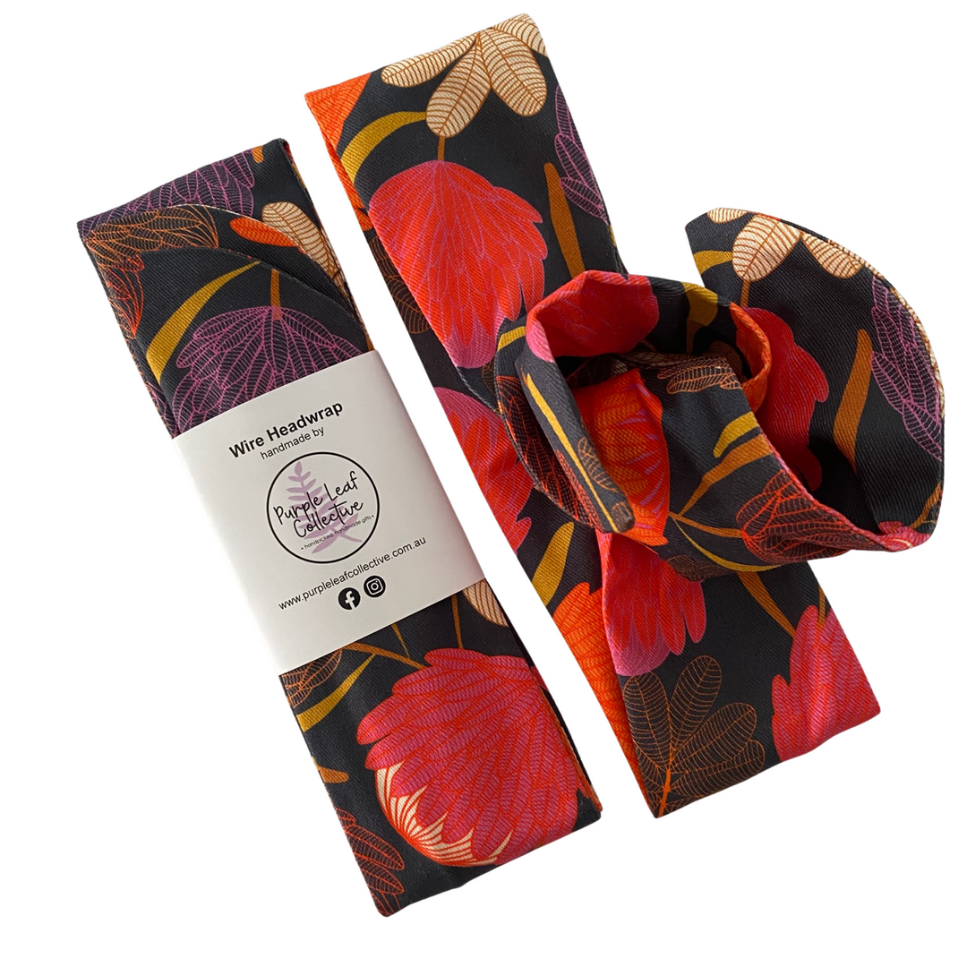 Wire headwrap with floral design and packaging on a white background.