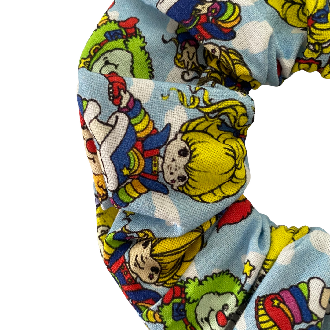 Close up view of colourful scrunchie with Rainbow Brite character design on a white background.