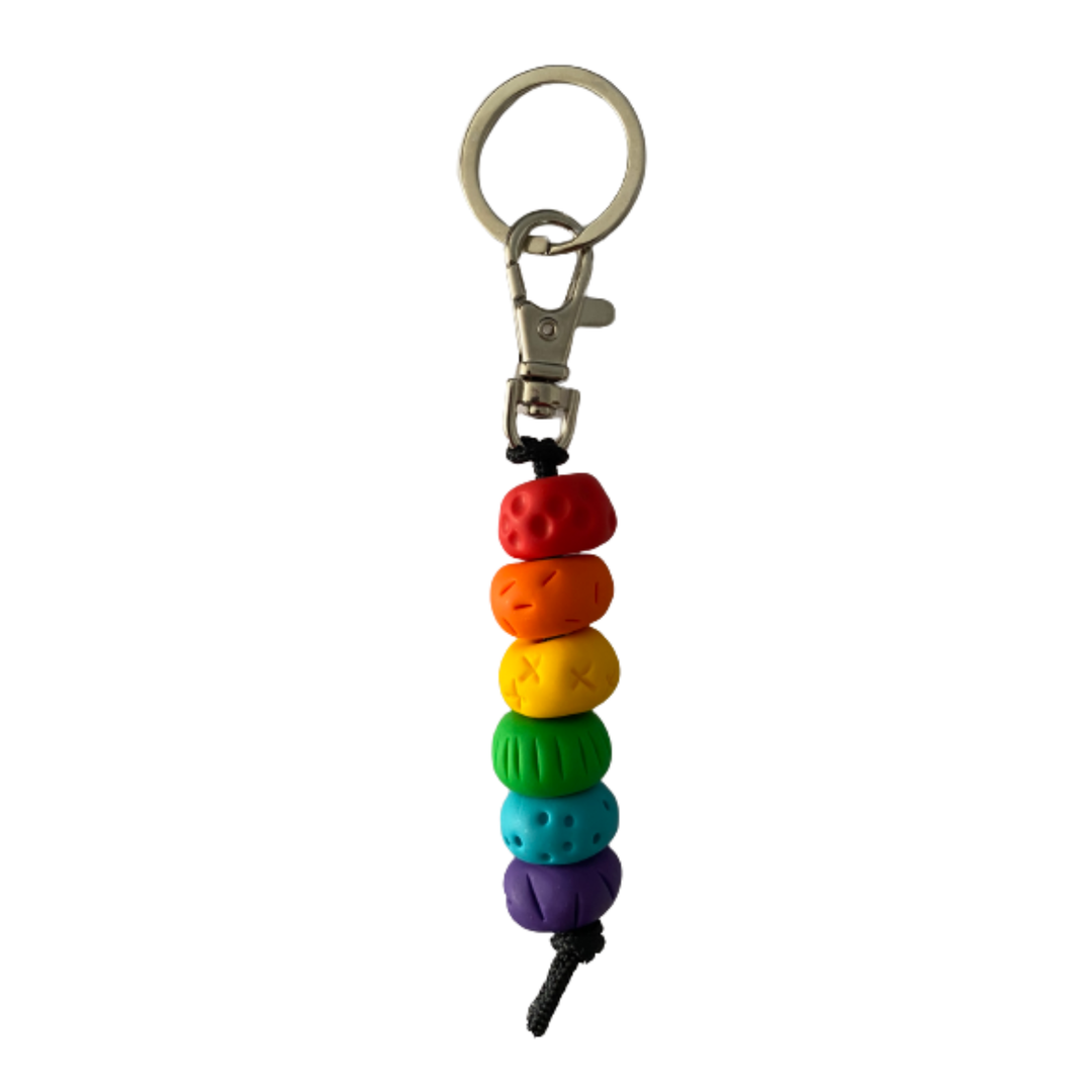 Handmade polymer clay keyring featuring six hand-rolled beads in a vibrant spectrum of red, orange, yellow, green, blue, and purple.attached to a silver clasp.