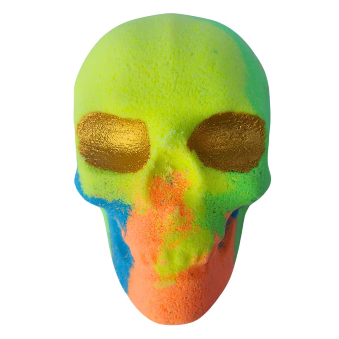 Skull bath bomb in tones of green, yellow, blue, and orange—complete with gold glitter eyes.