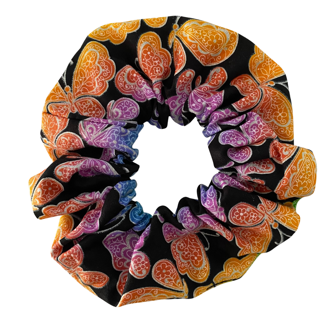 Colourful scrunchie with butterfly pattern on a black background.