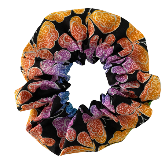 Colourful scrunchie with butterfly pattern on a black background.