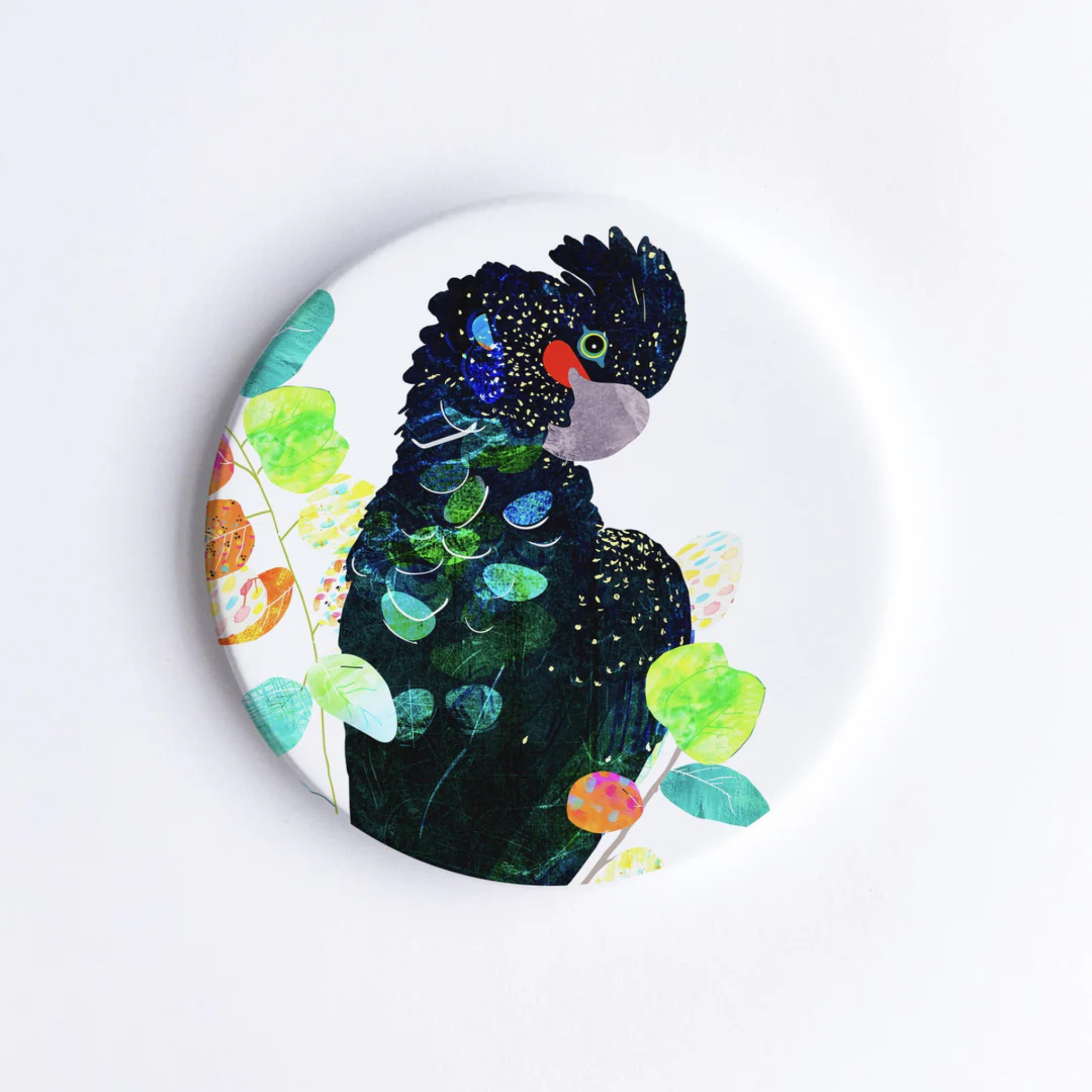 A 90mm diameter ceramic drink coaster featuring a picture of a Red-tailed Black Cockatoo.