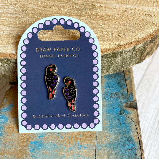 A pair of Red-tailed Black Cockatoo enamel stud earrings on a backing card.