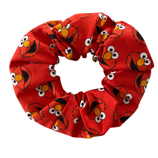Vibrant red scrunchie featuring Elmo face on a repeat pattern.