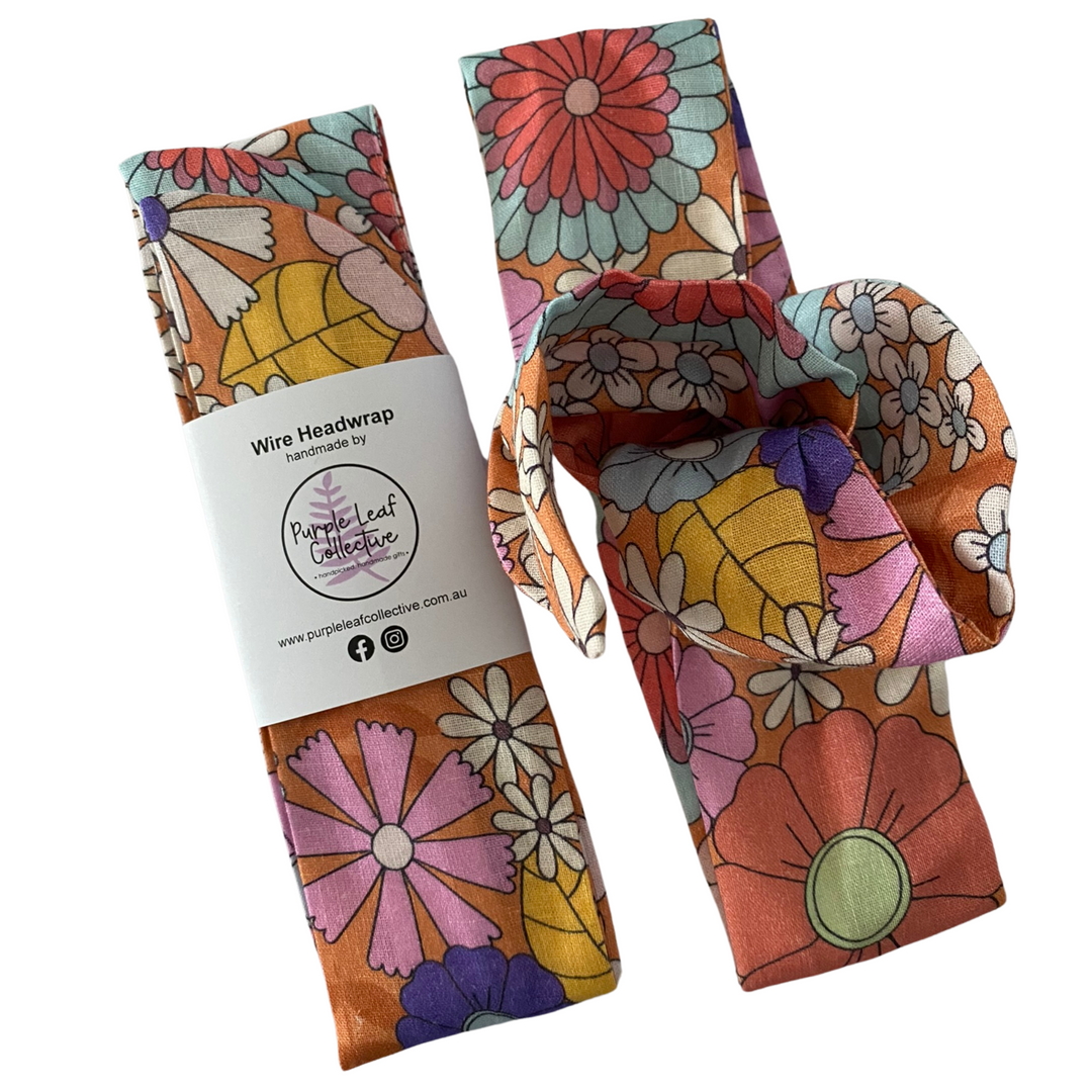 Colorful floral wire headwrap with packaging on a white background.