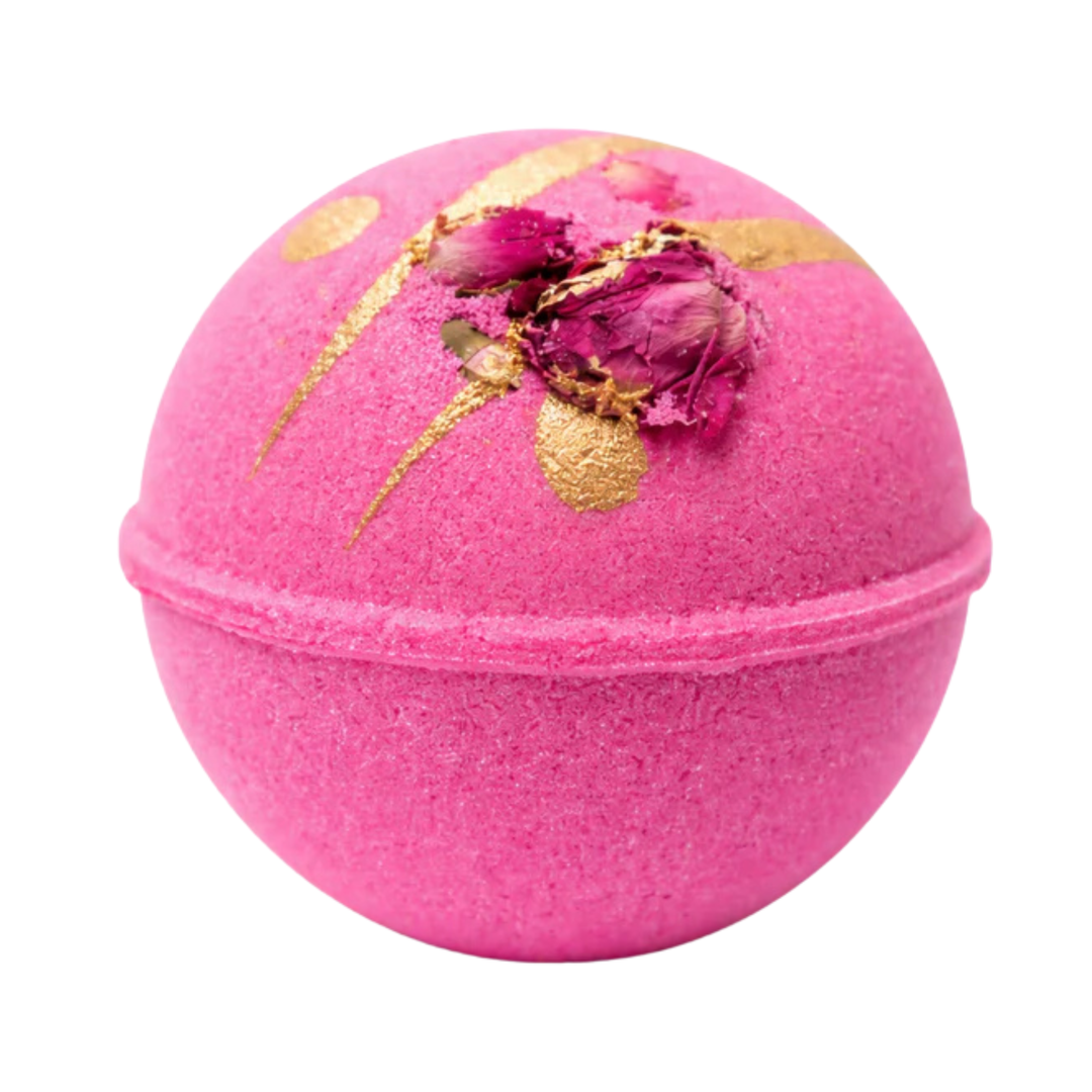 Pink bath bomb topped with gold glitter and rosebuds.