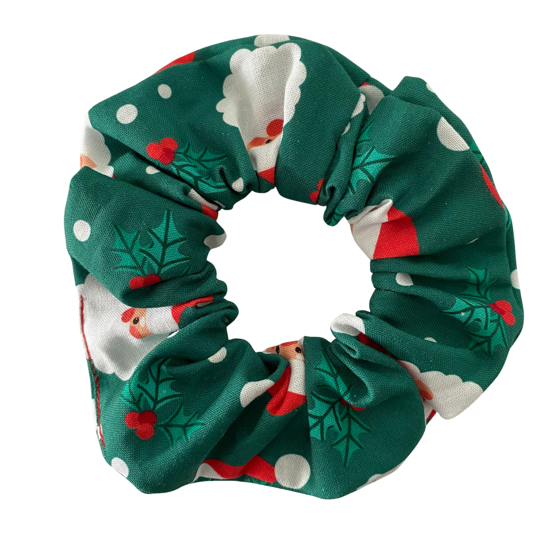 Green scrunchie with Santa Claus face pattern on a white background.