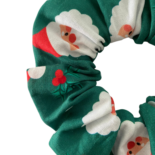 Santa Claus face pattern on a green scrunchie.