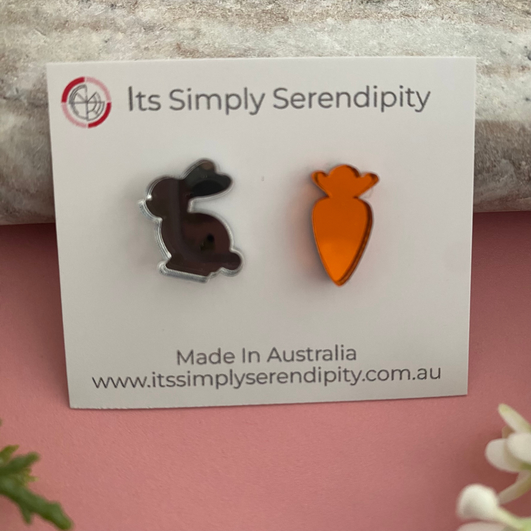 Silver bunny and carrot shaped earrings made from a vibrant mirrored acrylic.
