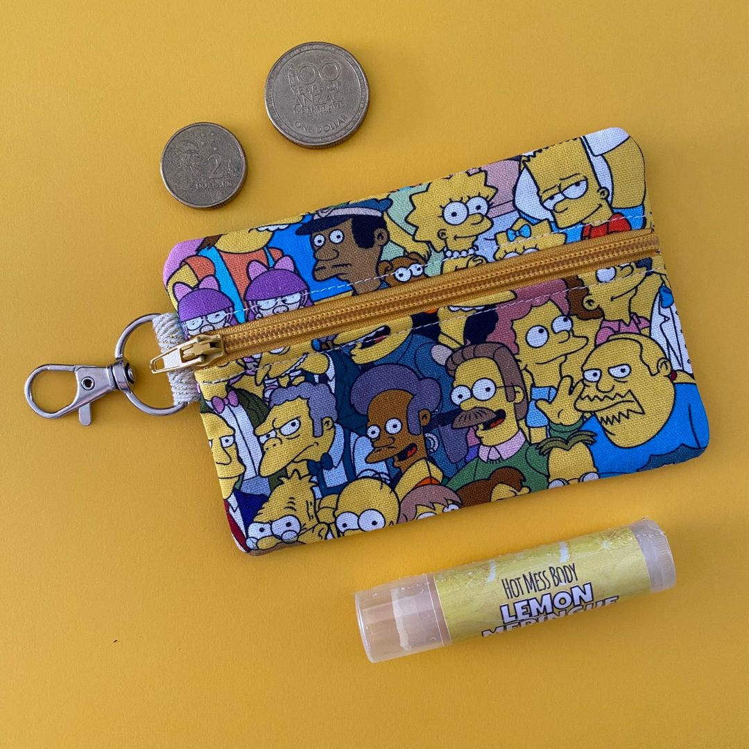 A small clip coin purse perfect for coins and small essentials featuring the Simpsons characters fabric.