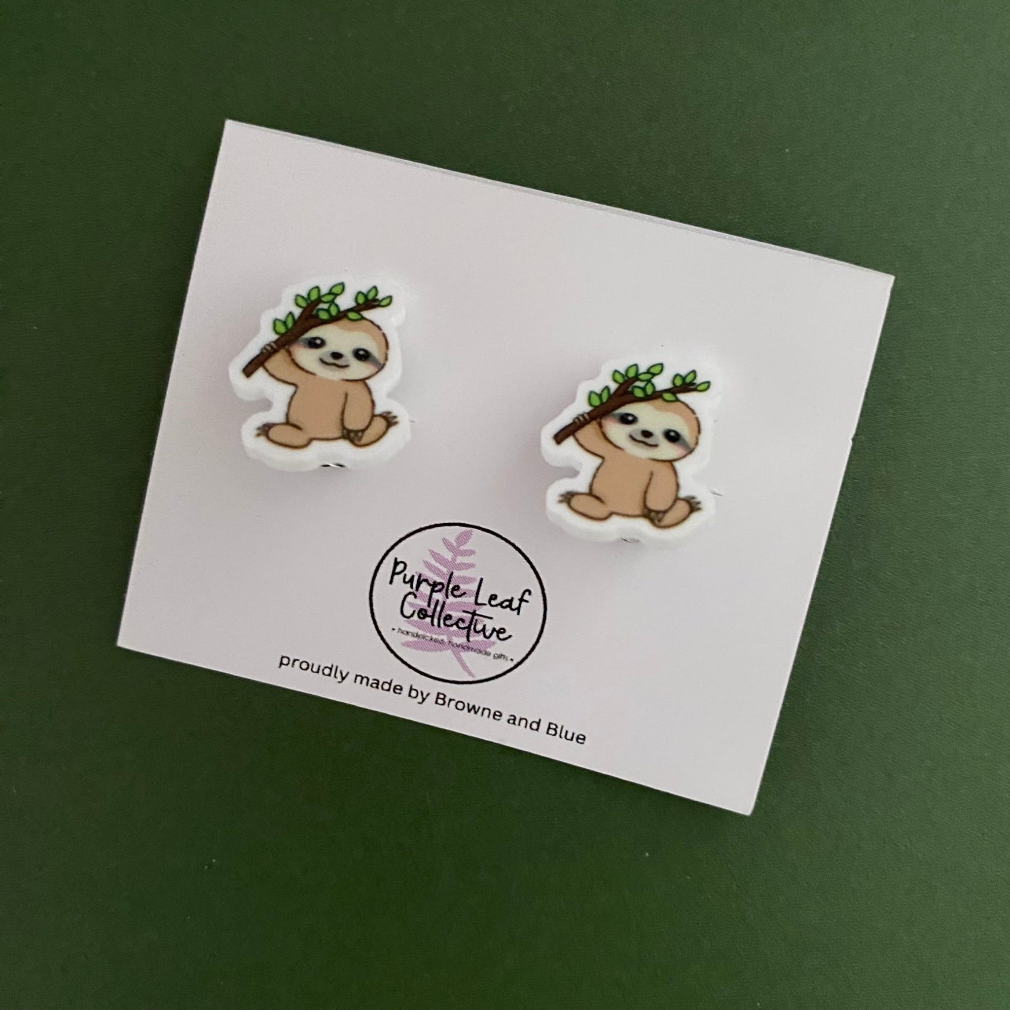 Sloths holding a tree branch novelty clip on stud earrings for non-pierced ears. Approx 12mm.