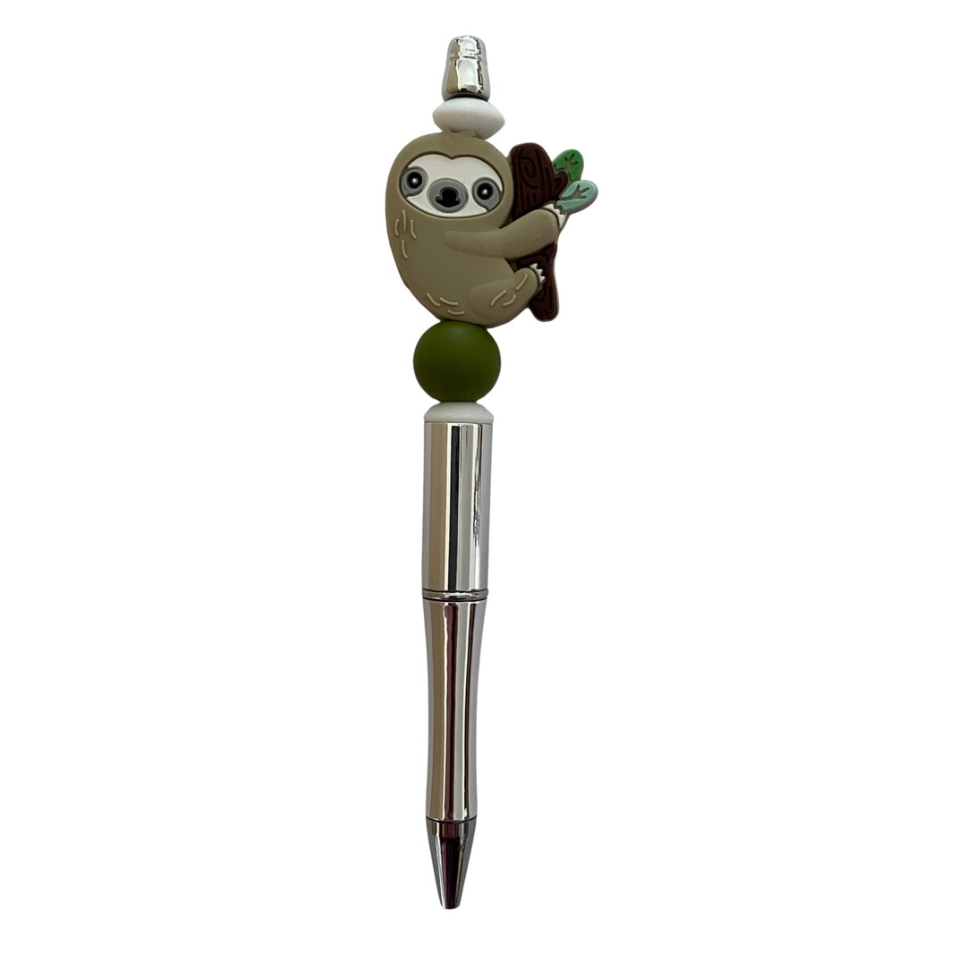 Pen with sloth charm on a white background.