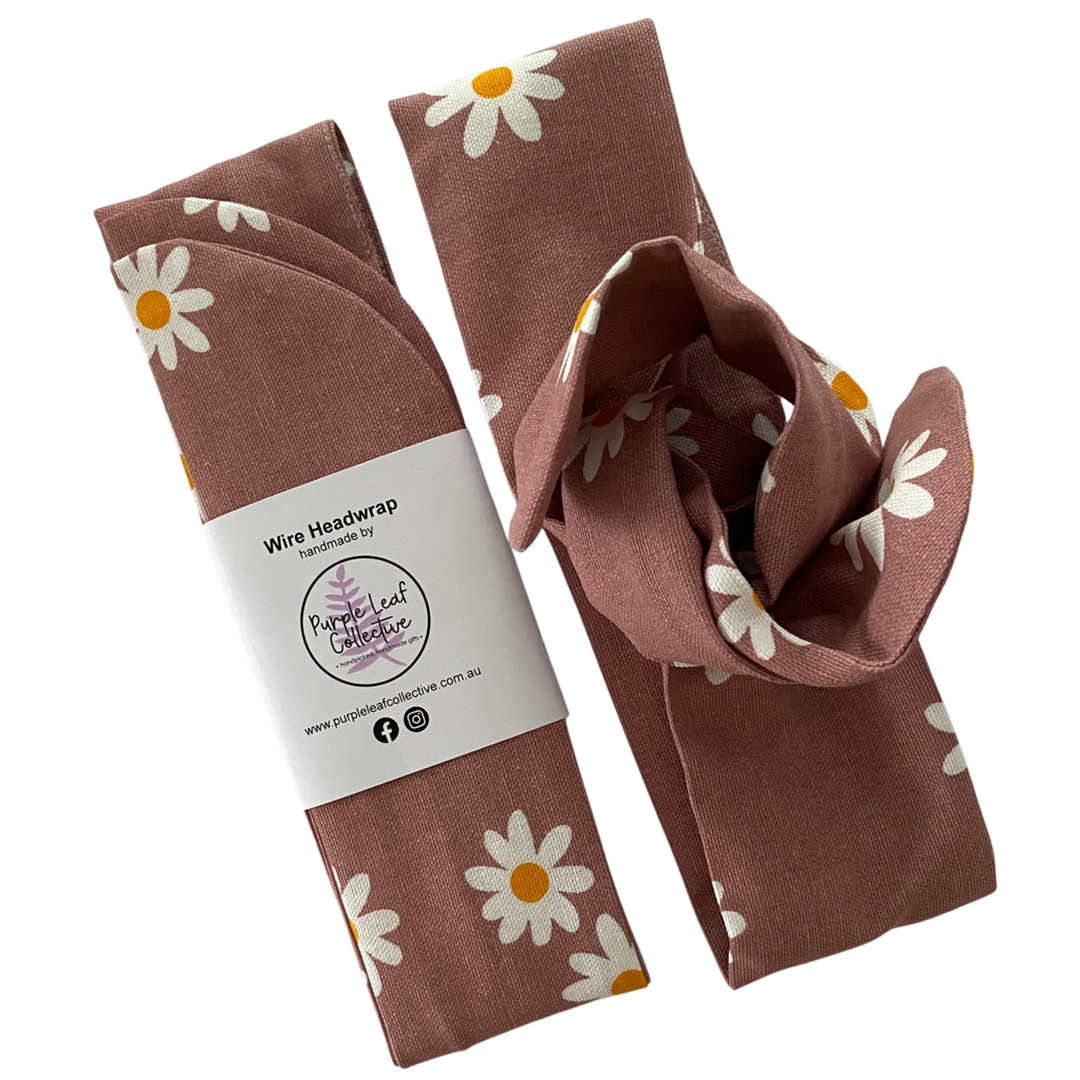 Handmade wire headwrap, headband with small daisy flowers set on pink fabric. Stylish, adjustable, and perfect for all-day wear or hair loss coverage.