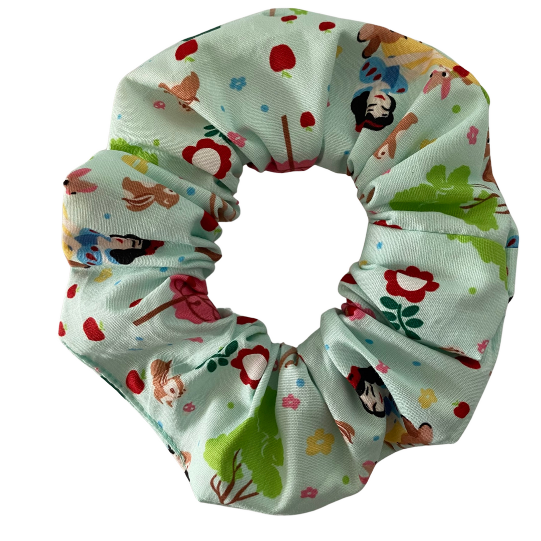 Snow White Scrunchie is handmade from soft cotton poplin and features sweet illustrations of Snow White with her woodland animal friends.