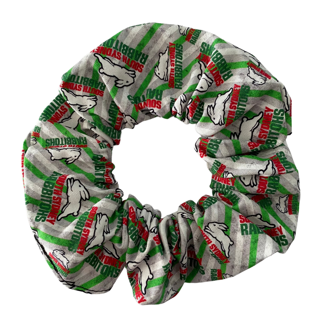 A scrunchie hair tie handmade with cotton woven fabric with images of the South Sydney Rabbitohs rugby league team.